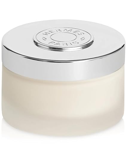White jar with silver lid featuring Hermès logo on a white background