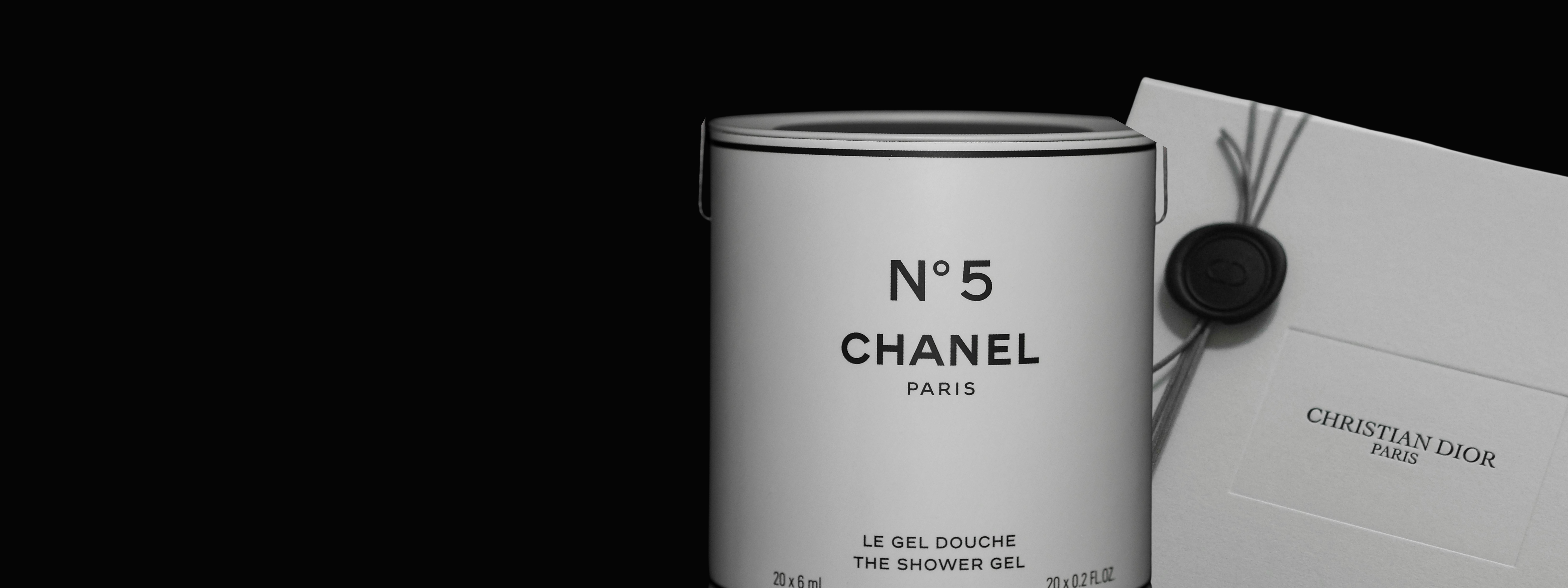Chanel No. 5 shower gel can with packaging on a black background