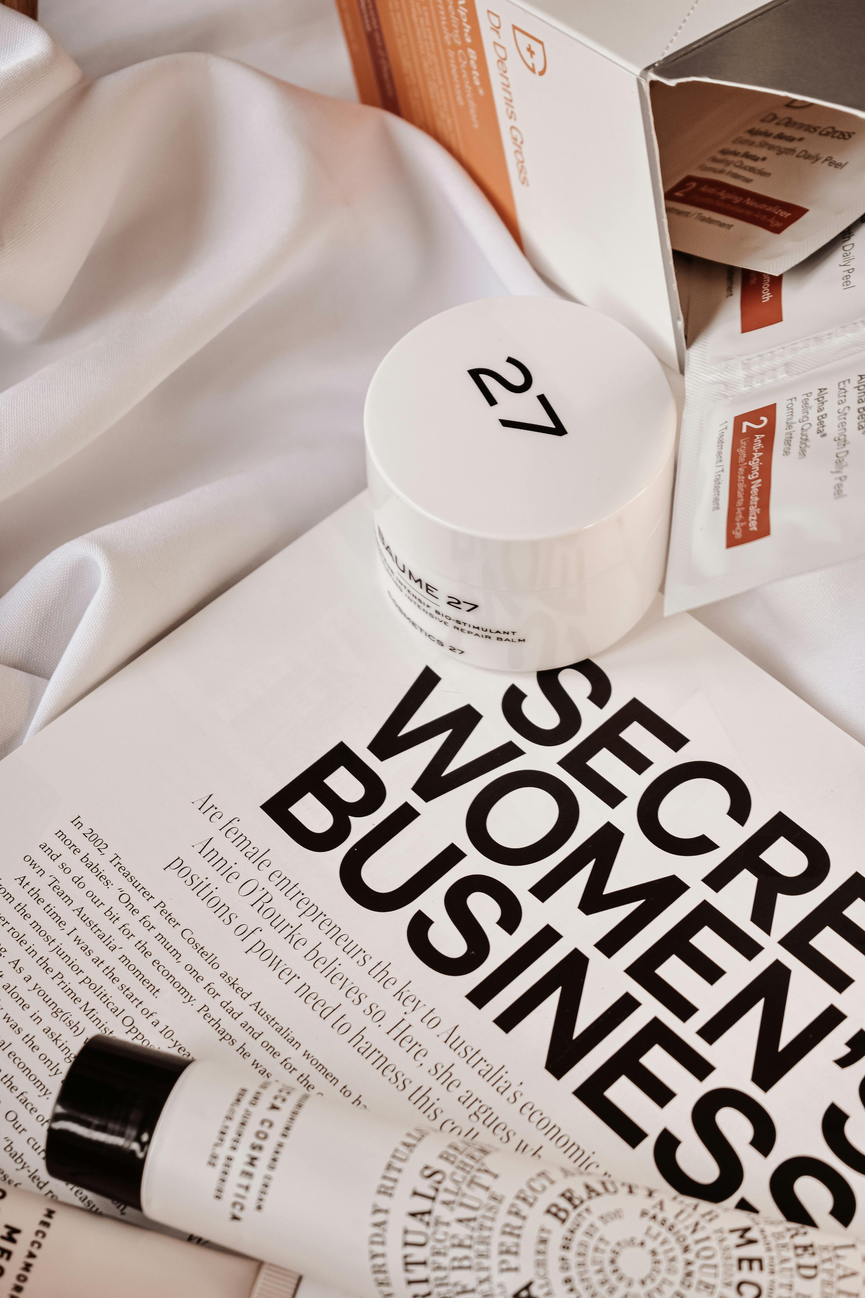 Cosmetic products on a magazine with 'skinarchives' branding